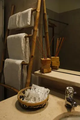 a bathroom sink with a basket on a counter with towels at Dazkarizeh73 in Ribeira Brava