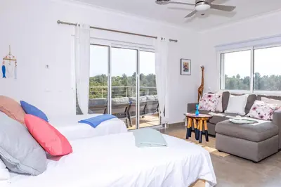 a living room with two beds and a couch at Villa Céu Do Sul in Burgau