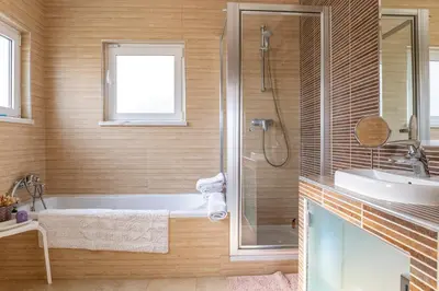 a bathroom with a bath tub and a sink at Villa Céu Do Sul in Burgau