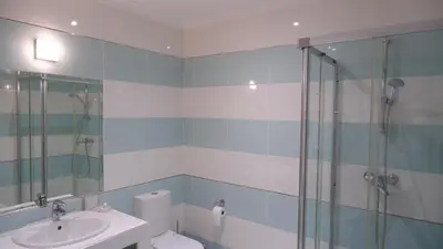 a bathroom with a shower and a toilet and a sink at Villa Céu Do Sul in Burgau