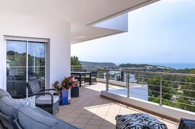 a balcony with furniture and a view of the ocean at Villa Céu Do Sul in Burgau