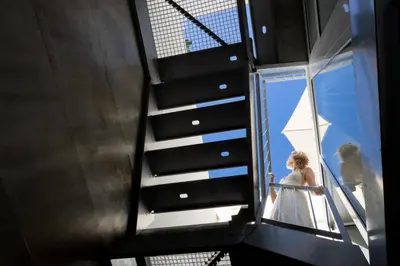 a bride walking down the stairs of a building at Fisherhouse23 in Câmara de Lobos