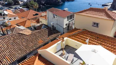 an aerial view of the roofs of a city at Fisherhouse23 in Câmara de Lobos