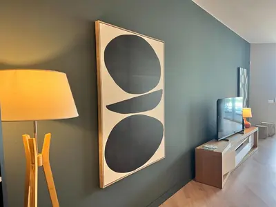 a living room with a tv and a lamp at Southern Skies Apartment in Funchal