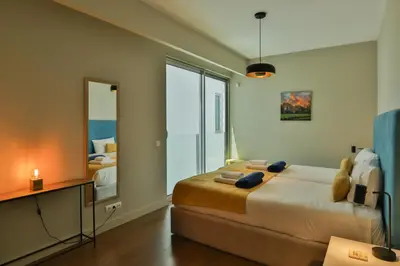 a bedroom with two beds and a large mirror at Southern Skies Apartment in Funchal