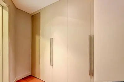 a closet with white cabinets in a room at Southern Skies Apartment in Funchal