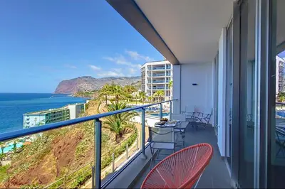 a balcony with chairs and a view of the ocean at Southern Skies Apartment in Funchal