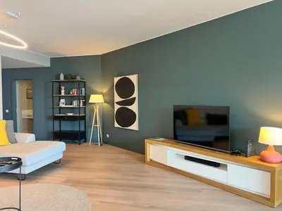 a living room with a couch and a flat screen tv at Southern Skies Apartment in Funchal