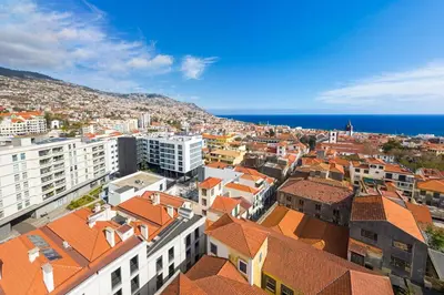 an aerial view of a city with buildings and the ocean at Santa Luzia III by An Island Apart in Funchal