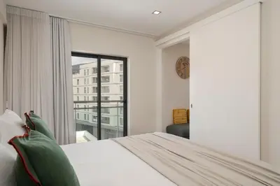 a bedroom with a bed and a large window at Santa Luzia III by An Island Apart in Funchal