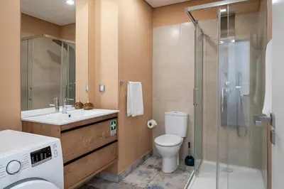 a bathroom with a toilet sink and a shower at Santa Luzia III by An Island Apart in Funchal