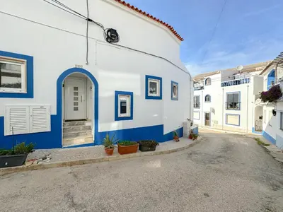 a blue and white building with a door at Refúgio na Praia de Burgau #1947 in Burgau