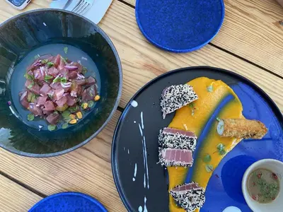a table with two plates of food and a salad at Refúgio na Praia de Burgau #1947 in Burgau