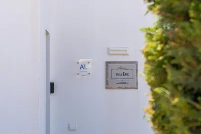 a white door with a wall get sign on it at Casa Epic in Sagres