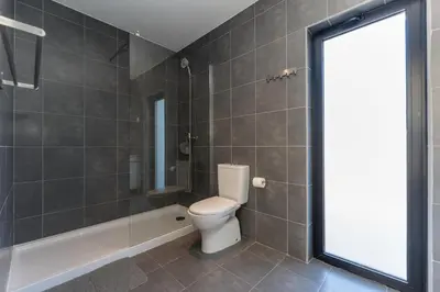 a bathroom with a toilet and a glass shower at Casa Epic in Sagres