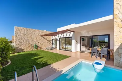 a villa with a swimming pool and a house at Casa Epic in Sagres
