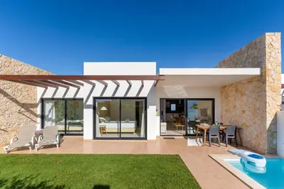 a house with a patio with a table and chairs at Casa Epic in Sagres