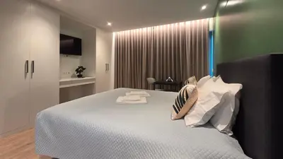 a bedroom with a bed with two towels on it at The Jolie - Lava Pools Apartments in Porto Moniz