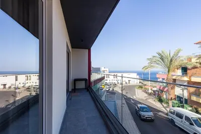 a balcony of a building with a view of a street at The Jolie - Lava Pools Apartments in Porto Moniz