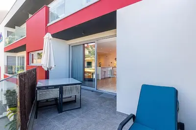 a house with a table on a balcony with a patio at The Jolie - Lava Pools Apartments in Porto Moniz