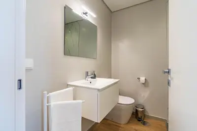 a bathroom with a sink and a toilet and a mirror at Villa Anita ,beautiful sunset in Arco da Calheta