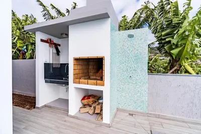 a bathroom with a tile wall and a sink at Villa Anita ,beautiful sunset in Arco da Calheta