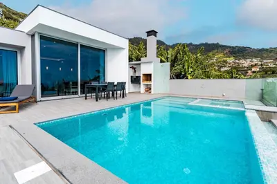 a swimming pool in the backyard of a house at Villa Anita ,beautiful sunset in Arco da Calheta