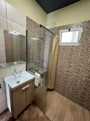 a bathroom with a shower and a sink at Fernanda's House in Ribeira Brava