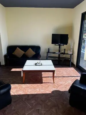 a living room with a couch and a coffee table at Fernanda's House in Ribeira Brava