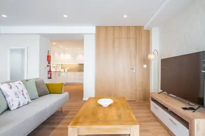 a living room with a couch and a table at Casa Magnólia in Funchal
