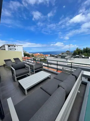 a balcony with couches and a view of the ocean at Funchal Lido Belo Horizonte in Funchal
