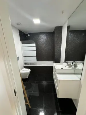 a bathroom with a sink and a tub and a toilet at Carreira Residence in Funchal