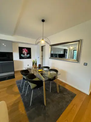 a dining room with a glass table and chairs at Carreira Residence in Funchal