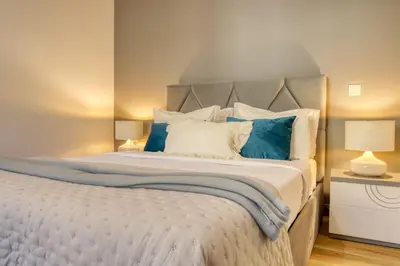 a bedroom with a large bed with blue and white pillows at Casa dos Anjos, a Home in Madeira in Faial