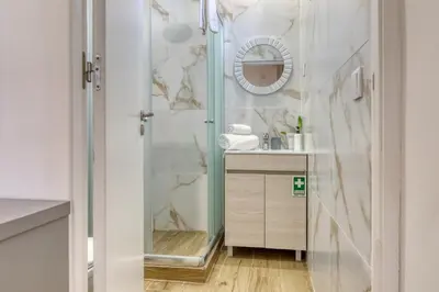 a bathroom with a shower with a mirror and a sink at Casa dos Anjos, a Home in Madeira in Faial