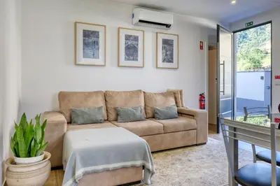 a living room with a couch and a table at Casa dos Anjos, a Home in Madeira in Faial