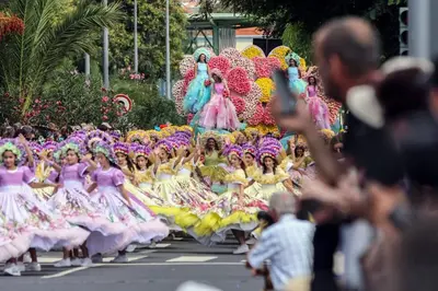 a group of girls in dresses in a parade at Casa Buganvília in Funchal
