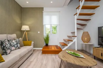 a living room with a couch and a table at Casa Buganvília in Funchal