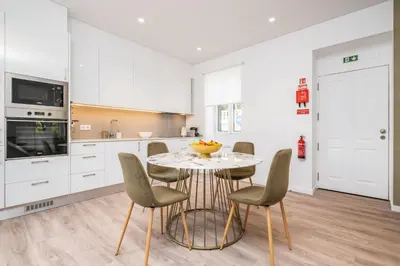 a kitchen with a table and chairs in a room at Casa Buganvília in Funchal