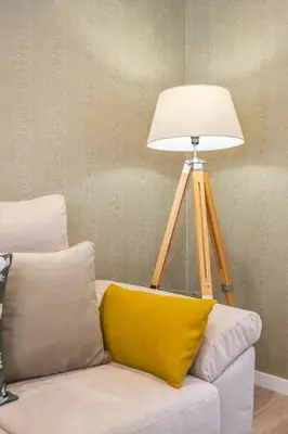 a lamp sitting on top of a couch with a yellow pillow at Casa Buganvília in Funchal