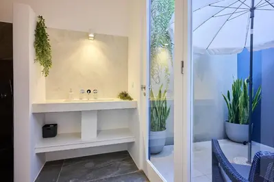 a bathroom with a sink and two potted plants at Luna Rossa by Homie in Funchal