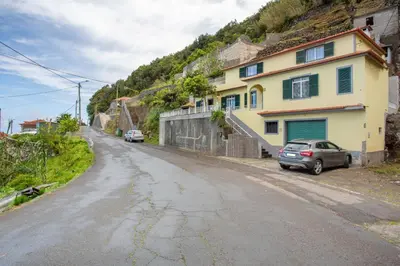 an empty street with a house on the side of a hill at Casa Estrela Do Norte in Ponta Delgada