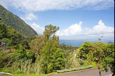 a view of the ocean from the side of a road at Casa Estrela Do Norte in Ponta Delgada