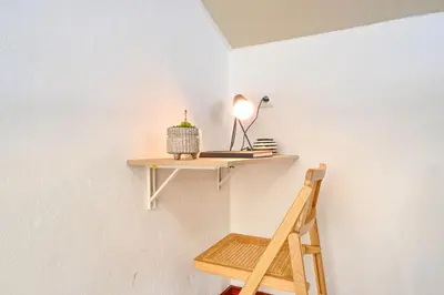 a shelf on a wall with a lamp and a ladder at Cantinho da Mikaela, A Home in Madeira in Ponta do Sol
