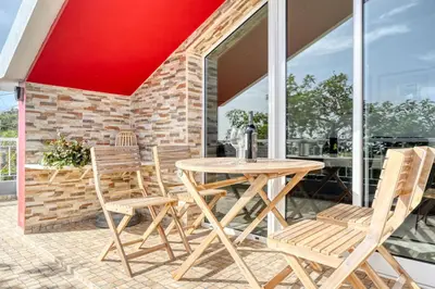 a wooden table and chairs on a patio at Cantinho da Mikaela, A Home in Madeira in Ponta do Sol