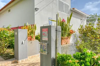 a fence with two refrigerators in front of a house at Cantinho da Mikaela, A Home in Madeira in Ponta do Sol