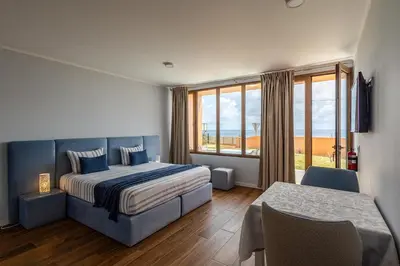 a bedroom with a bed and a large window at Praia Encantada in Porto Santo
