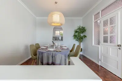 a dining room with a table and chairs at SUNSET VILLA in Caniço
