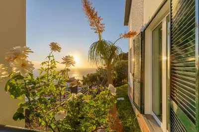 a window of a house with a view of the ocean at SUNSET VILLA in Caniço
