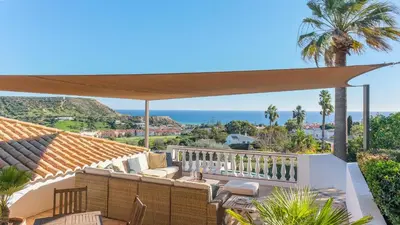 a patio with a view of the ocean at Casa das Palmeiras, Luxury Villa in Luz